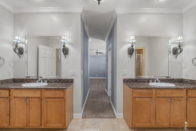 bathroom featuring tile patterned flooring, ceiling fan, ornamental molding, and vanity