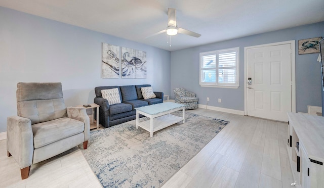 living room with light hardwood / wood-style flooring and ceiling fan