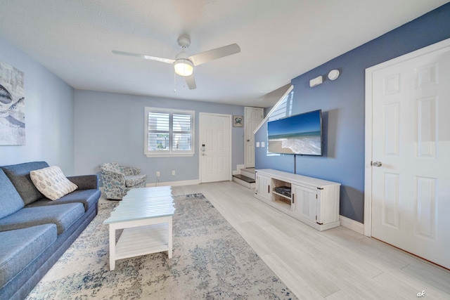 living room featuring ceiling fan and light wood-type flooring