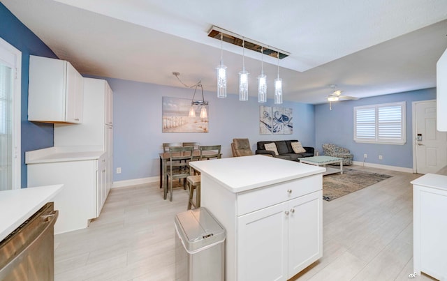 kitchen with ceiling fan, dishwasher, white cabinets, light hardwood / wood-style floors, and hanging light fixtures