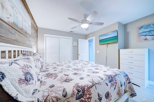 bedroom featuring wood-type flooring, a closet, and ceiling fan