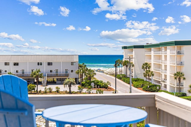 balcony with a water view and a beach view