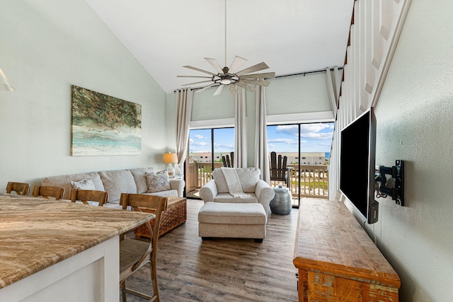 living room with ceiling fan, high vaulted ceiling, and dark hardwood / wood-style floors