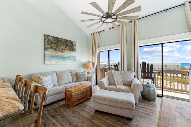 living room with high vaulted ceiling and dark wood-type flooring