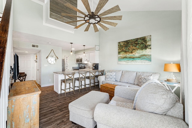 145 Beachfront Trl Unit 307A, Santa Rosa Beach, FL 32459 - living area with a ceiling fan, a high ceiling, dark wood-style flooring, and baseboards