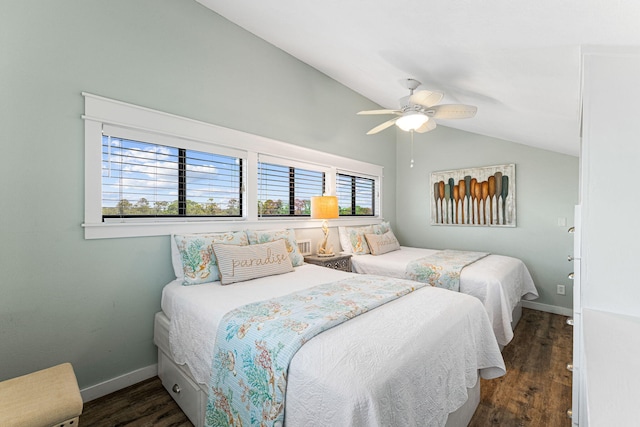 bedroom featuring dark hardwood / wood-style flooring, multiple windows, lofted ceiling, and ceiling fan