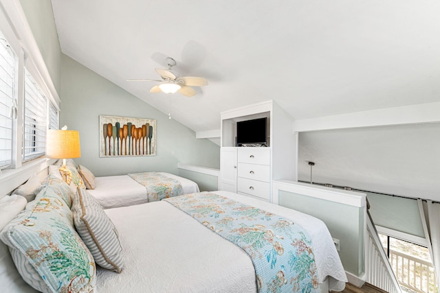 bedroom featuring ceiling fan, hardwood / wood-style floors, and vaulted ceiling