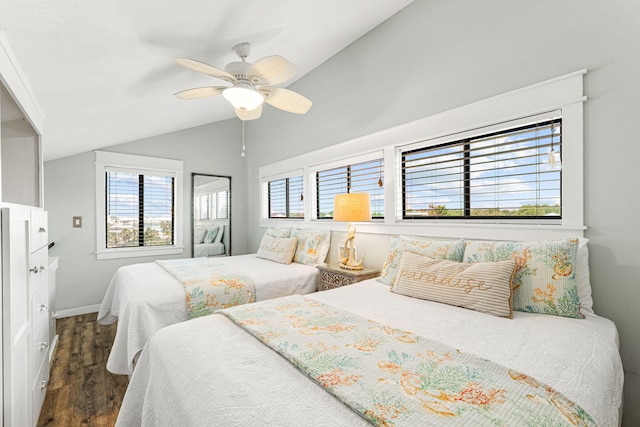 bedroom featuring ceiling fan, dark wood-type flooring, and lofted ceiling