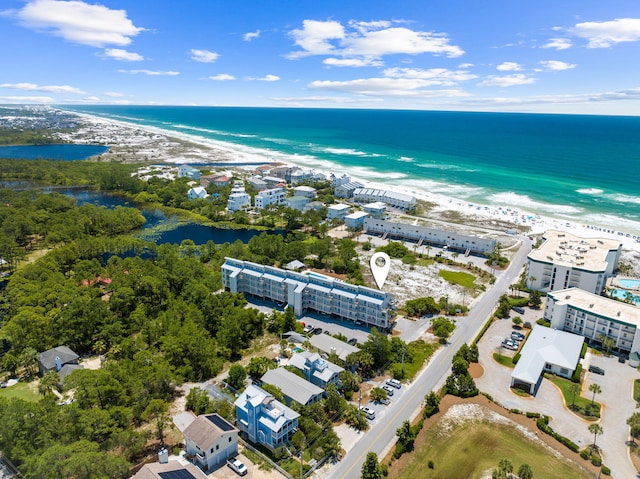 birds eye view of property with a beach view and a water view