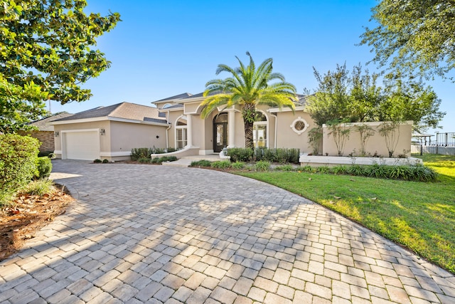 view of front of house featuring a garage and a front lawn