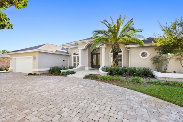 view of front of home with french doors and a garage