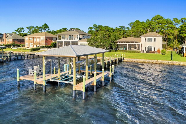 view of dock featuring a water view and a lawn