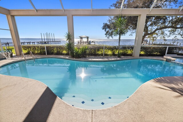 view of pool featuring a water view and a patio area