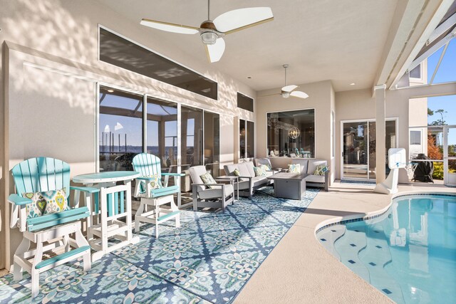 view of pool featuring outdoor lounge area, ceiling fan, and a patio area