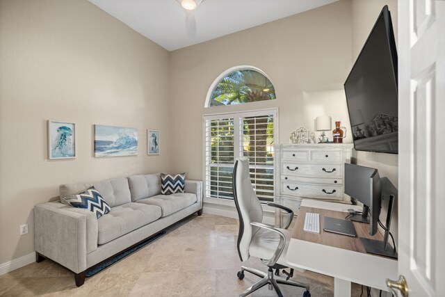 office with a high ceiling and ceiling fan