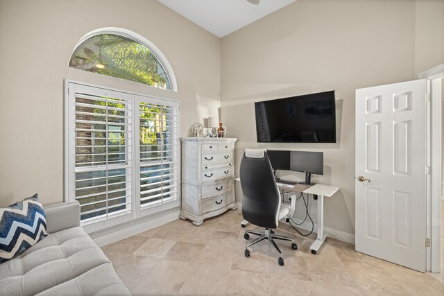 home office featuring high vaulted ceiling