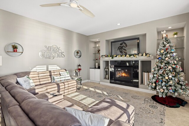 living room with a fireplace, tile patterned floors, and ceiling fan