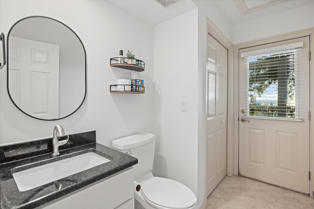 bathroom with tile patterned floors, vanity, and toilet