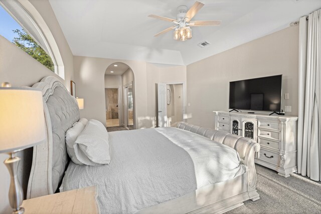 carpeted bedroom with connected bathroom, ceiling fan, and lofted ceiling