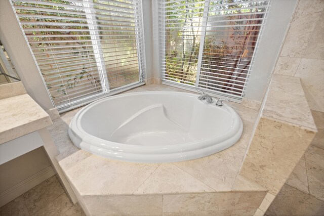 bathroom featuring vanity and a tub to relax in