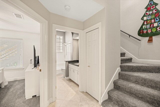 stairway with tile patterned floors