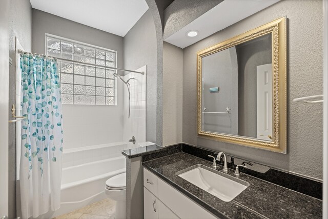 full bathroom with shower / tub combo, vanity, toilet, and tile patterned floors