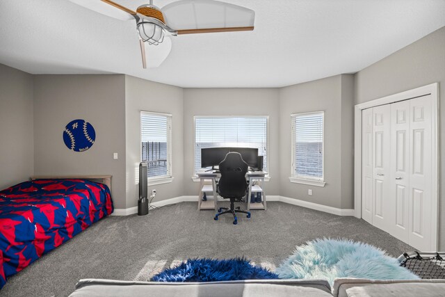 carpeted bedroom featuring a closet and ceiling fan