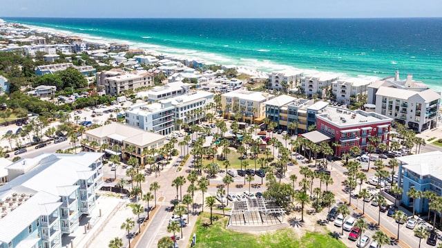 aerial view with a water view and a beach view