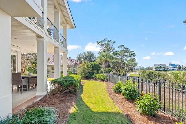 view of yard with a balcony and a patio