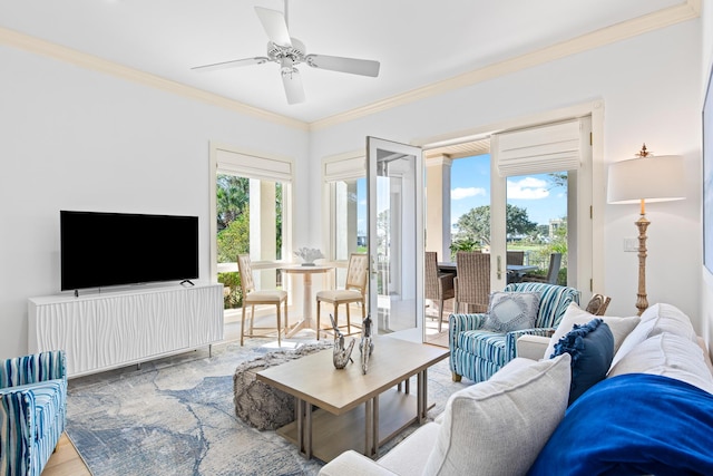 living room with light hardwood / wood-style flooring, ceiling fan, and crown molding