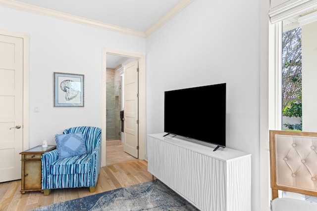 living area with ornamental molding and light wood-type flooring