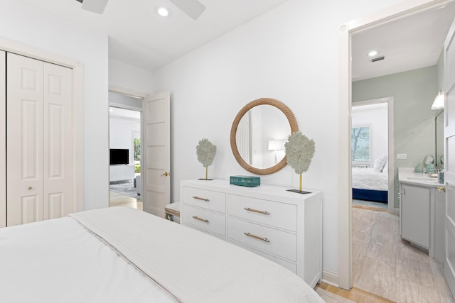 bedroom featuring ceiling fan, a closet, light wood-type flooring, and multiple windows