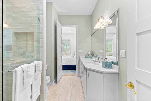 bathroom featuring hardwood / wood-style floors, plenty of natural light, toilet, and vanity