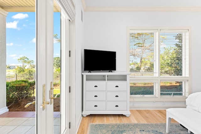 sitting room with light hardwood / wood-style flooring, a healthy amount of sunlight, and crown molding