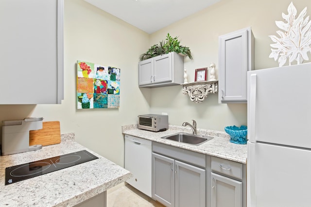 kitchen with gray cabinets, white appliances, and sink