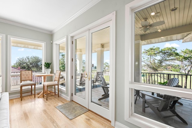 doorway to outside with french doors, light wood-type flooring, ceiling fan, and ornamental molding