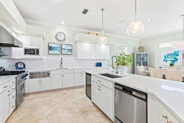 kitchen featuring pendant lighting, sink, white cabinets, and stainless steel appliances