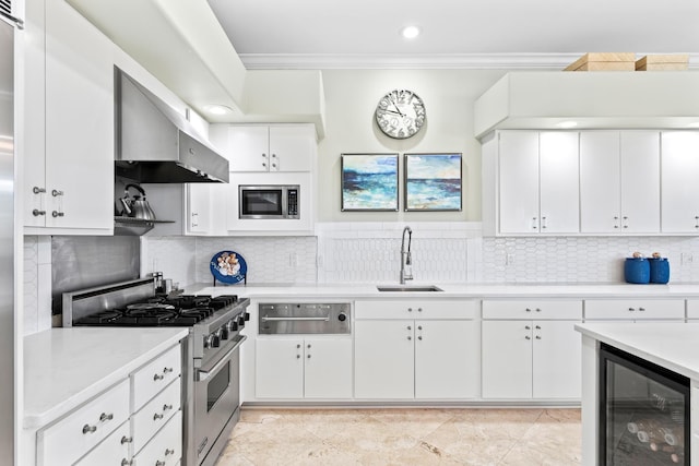 kitchen featuring stainless steel appliances, crown molding, sink, white cabinetry, and wine cooler