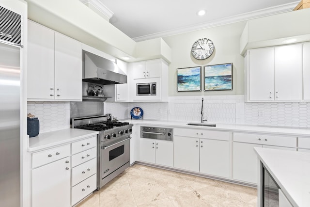 kitchen with white cabinets, built in appliances, wall chimney exhaust hood, and sink