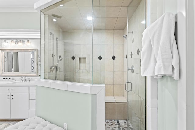 bathroom with wood-type flooring, vanity, an enclosed shower, and crown molding