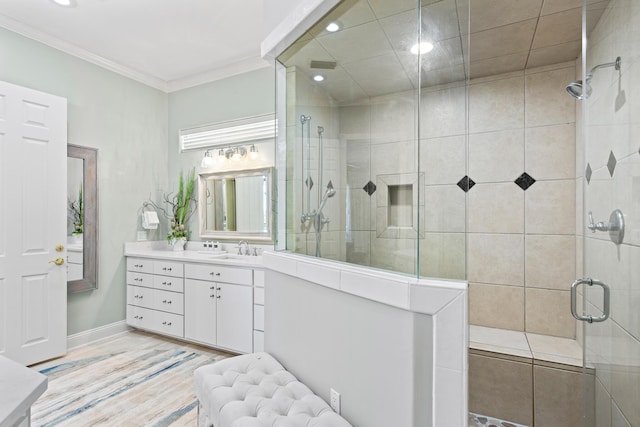 bathroom with hardwood / wood-style floors, vanity, an enclosed shower, and ornamental molding