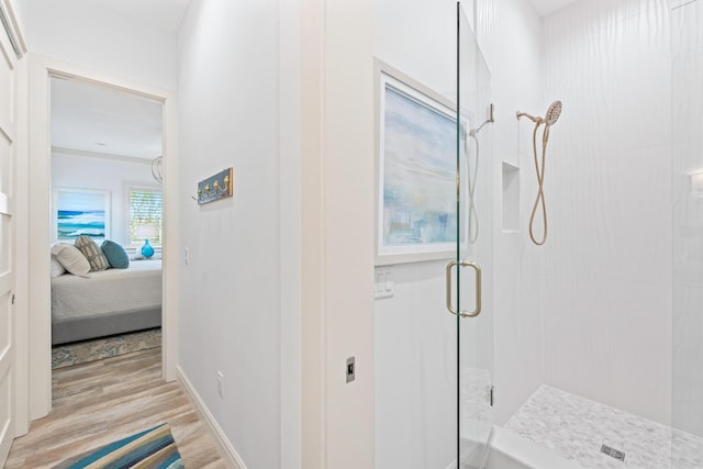 bathroom featuring wood-type flooring and walk in shower