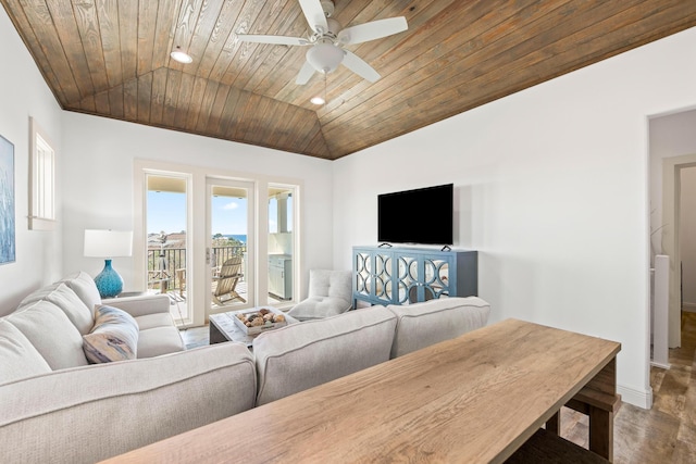 living room with ceiling fan, wood ceiling, and vaulted ceiling