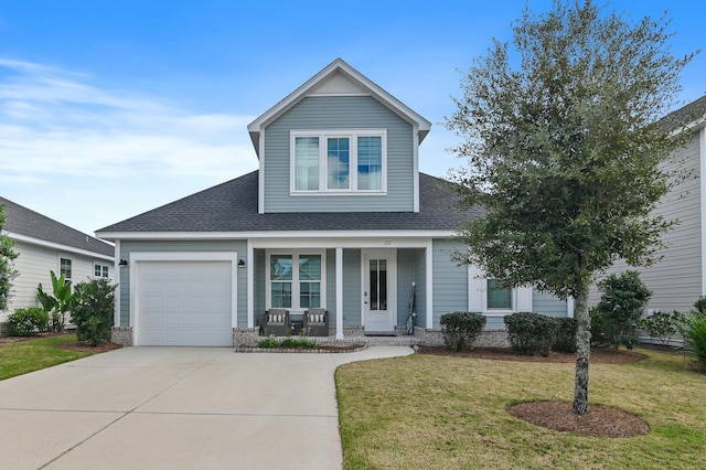 view of front of house featuring covered porch, a front yard, and a garage