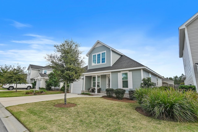 view of front of house with a porch, a garage, and a front lawn