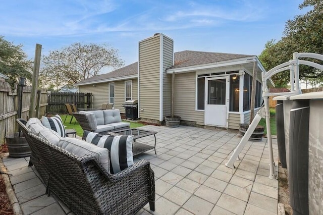 view of patio featuring area for grilling, an outdoor living space, and a sunroom