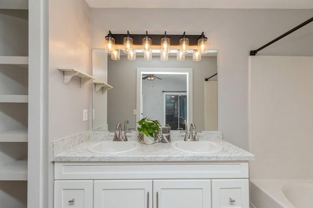 bathroom with shower / bathtub combination, vanity, and ceiling fan