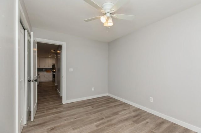 unfurnished room with ceiling fan and light hardwood / wood-style flooring