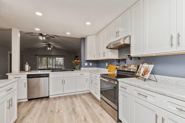 kitchen featuring white cabinets, sink, stainless steel appliances, and vaulted ceiling