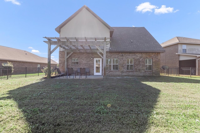 back of house with a pergola, a patio area, and a lawn